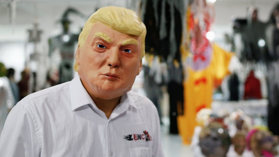 A person wearing a Donald Trump mask, fresh off the factory floor, in China.