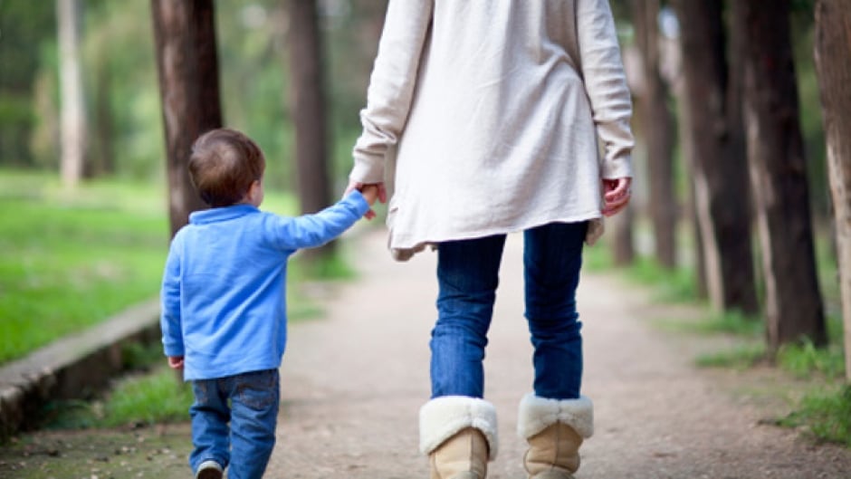 Woman with her kid walking in a park