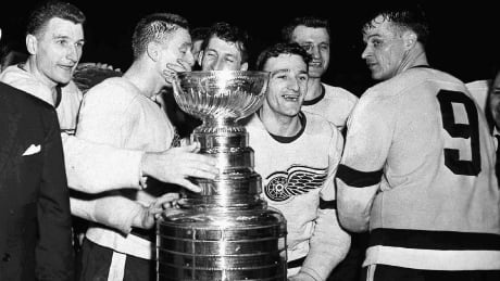 Members of Detroit Red Wings, inclduing Gordie Howe (right), surround the Stanley Cup in this 1955 photo, after beating the Montreal Canadiens. HKN OBIT Gordie Howe 20160610
