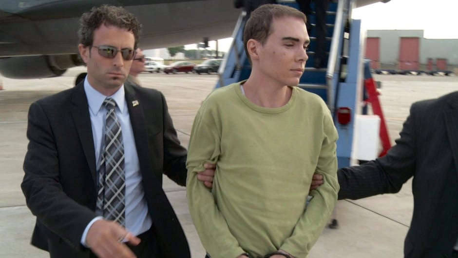 Luka Rocco Magnotta is taken by police from a Canadian military plane to a waiting van on Monday, June 18, 2012 in Mirabel, Que.