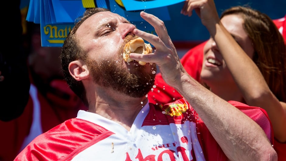 NEW YORK, NY - JULY 4: Joey Chestnut competes in the annual Hot Dog Eating Contest at Coney Island July 4, 2016 in New York City. Joey Chestnut re-took the crown, eating 70 hot dogs and beating last year's winner Matt Stonie's 53 hot dogs consumed. (Photo by Eric Thayer/Getty Images)