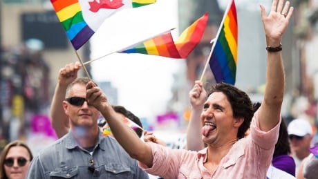 Prime Minister Justin Trudeau waves a flag as he takes part in the annual Pride Parade in Toronto on July 3. Toronto Pride Parade 20160703