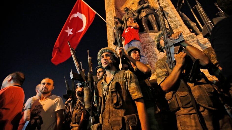 Turkish soldiers secure the area, as supporters of Turkey's President Recep Tayyip Erdogan protest in Istanbul's Taksim square, early Saturday, July 16, 2016.