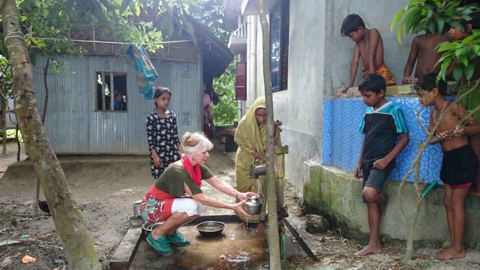 Dr. Judit Smits collecting well water with Bangladeshi villager