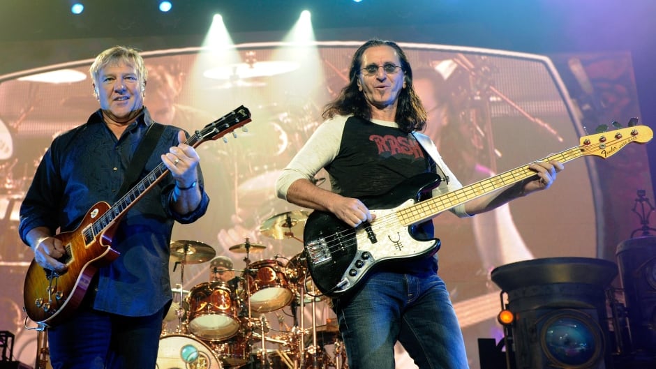 LAS VEGAS - AUGUST 14: (L-R) Rush guitarist Alex Lifeson, drummer Neil Peart and singer/bassist Geddy Lee perform at the MGM Grand Garden Arena during a stop of the band's Time Machine Tour August 14, 2010 in Las Vegas, Nevada. (Photo by Ethan Miller/Getty Images)