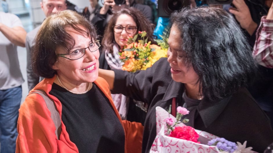 Homa Hoodfar is welcomed as she arrives at Trudeau Airport Thursday, September 29, 2016 in Montreal. Hoodfar, a Canadian-Iranian academic was held in Iran's Evin prison for more than 100 days.