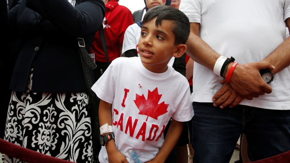 A Syrian refugee waits to shake hands with the Prime Minister on Canada Day, 2016. Journalist Anita Li argues Canadians have a smug attitude about multiculturalism in Canada, and says the media help maintain it by not speaking openly and frankly about race.