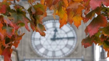 Changing autumn leaves frame the clock on the Peace Tower on Parliament Hill in Ottawa on Sept. 24, 2010. Ottawa Fall Weather