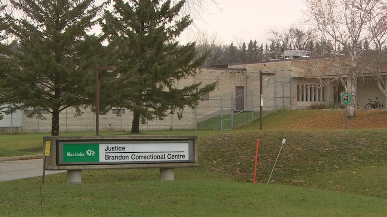 A sign in front of a building says "Manitoba Justice Brandon Correctional Centre."