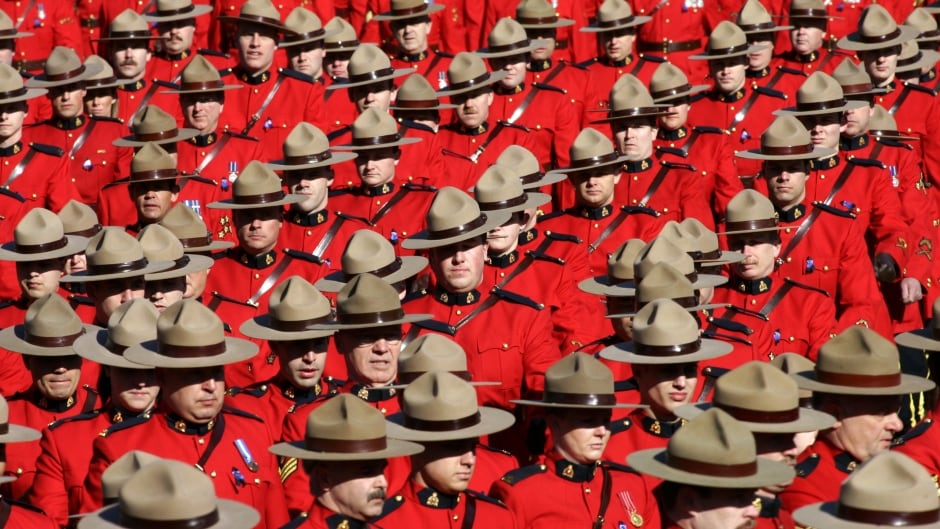 Royal Canadian Mounted Police officers march during a memorial for four slain officers in Edmonton, Alberta, in this March 10, 2005 file photo. The head of the troubled RCMP admitted on December 14, 2007 that the national force needed a major overhaul to deal with a widespread lack of morale, scarce resources and heavy public criticism. REUTERS/Shaun Best (CANADA) - RTX4QVH