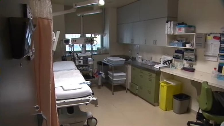 A room with a white stretcher and medical equipment