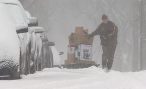 UPS delivery man uses sled during Winnipeg storm