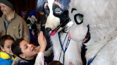 Syrian refugee children mobbed the furries, giving them hugs and dancing with them. Furries meet Syrian refugees