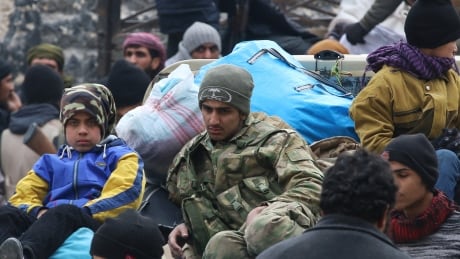 Rebel fighters and civilians gather as they wait to be evacuated from a rebel-held sector of eastern Aleppo, Syria December 16, 2016. MIDEAST-CRISIS/SYRIA