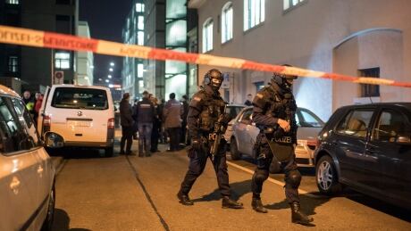 Special Unit Policemen secure the area in front of the Islamic centre in Zurich on Monday. A police official said a gunman has injured several people in Switzerland's largest city. Switzerland Shooting