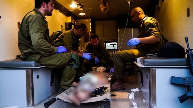 Israeli army medics tend to an injured Syrian in the occupied Golan Heights. 