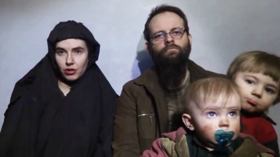 A still image from a video posted by the Taliban on social media on December 19, 2016 shows American Caitlan Coleman (L) speaking next to her Canadian husband Joshua Boyle and their two sons.
