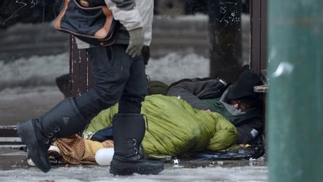 A homeless man sleeps in a doorway in Vancouver's Downtown Eastside, Monday, Dec.19, 2016. Vancouver Downtown Eastside 20161219