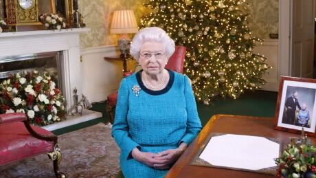 In this photo released early Sunday Dec. 25, 2016, Britain's Queen Elizabeth II poses for a photo, sitting at a desk in the Regency Room of Buckingham Palace in London, after recording her traditional Christmas Day broadcast to the Commonwealth. Queen Elizabeth prerecords her traditional Christmas Day festive speech to be broadcast to the British Commonwealth nations on Christmas Day. Britain Queen