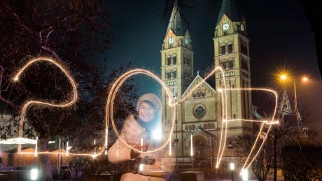 A young woman writes '2017' using a sparkler during the New Year's Eve celebrations in Nyiregyhaza, Hungary. Hungary New Year 2017
