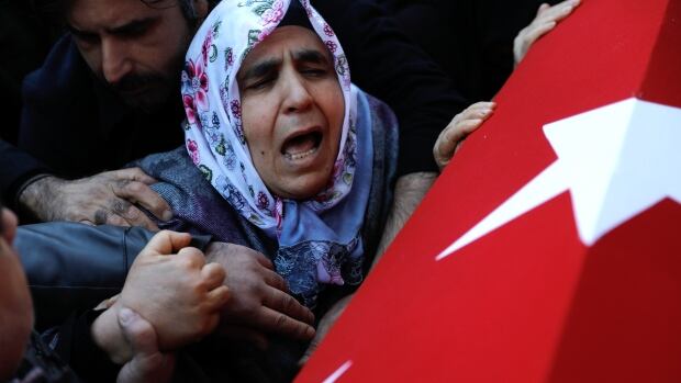 The mother of Fatih Cakmak, a security guard and a victim of the attack, cries at his funeral in Istanbul on Monday.