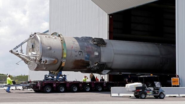 The recovered first stage of a SpaceX Falcon 9 rocket is transported to the SpaceX hangar at the Kennedy Space Center in Cape Canaveral, Florida on May 14, 2016. The vehicle was launched May 16 and successfully recovered, but on Sept. 1, another Falcon 9 blew up on the launch pad, stalling its satellite program.