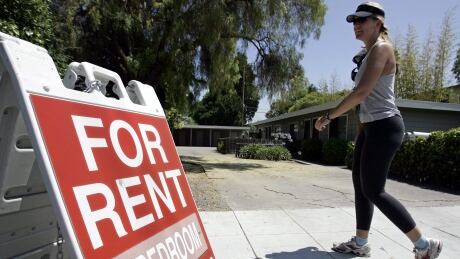 FILE - In this July 19, 2006 file photo, a woman walks next to a "For Rent" sign at an apartment complex in Palo Alto, Calif. Real estate data firm Zillow reports on U.S. home rental prices in December 2014 on Friday, Jan. 23, 2015. (AP Photo/Paul Sakuma, File) Home Rental Prices