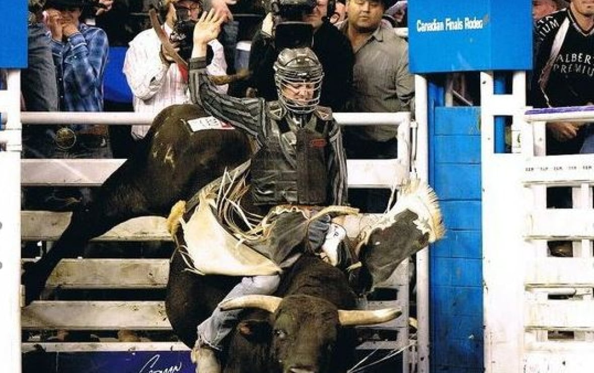 A man rides a bucking bull