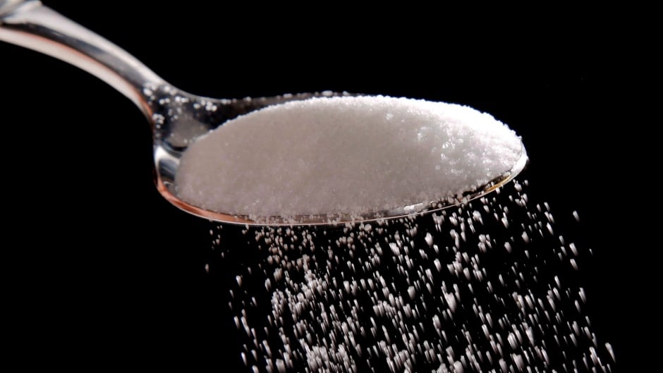 Granulated sugar is poured in Philadelphia, Monday, Sept. 12, 2016 in a photo illustration. Researchers checking for added sugar on the ingredients list of packaged foods and beverages expected to find it in candy products, but they didn't predict the high levels they would find in baby food, snack bars and beverages.