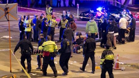 FILE - In this March 12, 2014, file photo, paramedics transport a person who was struck by a car on Red River Street in downtown Austin, Texas, during the South by Southwest music festival. An Austin police officer who worked security at last year’s festival on Monday, Nov. 2, 2015, described the chaotic scene when a speeding car plowed into a crowd of people, leaving four dead and more than 20 hurt. AUSTIN CHRONICLE OUT, COMMUNITY IMPACT OUT, INTERNET AND TV MUST CREDIT PHOTOGRAPHER AND STATESMAN.COM, MAGAZINES OUT; MANDATORY CREDIT; NO SALES South By Southwest Fatal Crash
