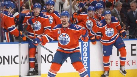 Matt Hendricks, centre, celebrates the Oilers' shootout win over the Flames. edmonton-oilers