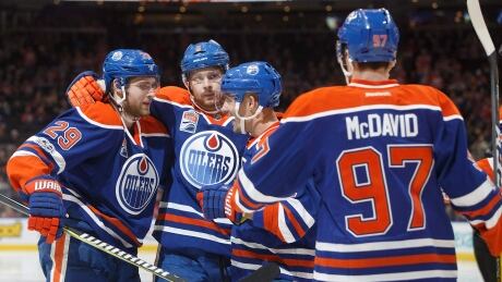 Edmonton Oilers' Connor McDavid celebrates his 100th career point with teammates against the Florida Panthers on Wednesday. McDavid-Connor-01122017