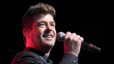 FILE - In this Aug. 7, 2015 file photo, Robin Thicke performs during the Steve Harvey Morning Show live broadcast at the Georgia World Congress Center in Atlanta. A judge has ordered Thicke to stay away from his ex-wife, actress Paula Patton and only have monitored visits with his 6-year-old son. Los Angeles Superior Court Judge Colin Leis issued the temporary restraining order on Thursday, Jan. 26, 2017, after Patton accused the singer of physically abusing her during their marriage, which ended in March 2015. People Robin Thicke