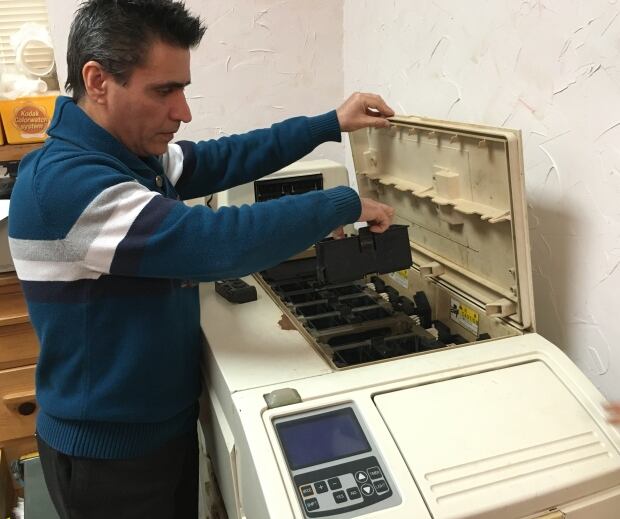 Keyvan Ashenaei shows off old film developing machine