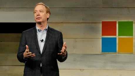Brad Smith, Microsoft Corp.'s General Counsel and Executive Vice President of Legal and Corporate Affairs, greets attendees at Microsoft Corp.'s annual shareholders meeting, Wednesday, Dec. 3, 2014, in Bellevue, Wash. Microsoft Shareholders Meeting
