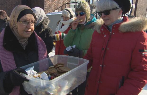 Wafia Hammoud hands out cookies to 'human chain' participants at Ottawa Mosque