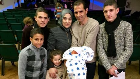 Ibtesam (second from left) & Medyan Alkarnake (second from right), their newborn Eyad and their four other children attended Fort McMurray's Fort City Church Sunday to meet their sponsors. Pic 5 Alkarnake refugee mom