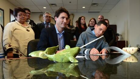 Prime Minister Justin Trudeau takes part in a signing ceremony with president of the Inuit Tapiriit Kanatami Natan Obed following a meeting with ITK members as he visits Iqaluit on Thursday, Feb. 9. Trudeau Arctic 20170209