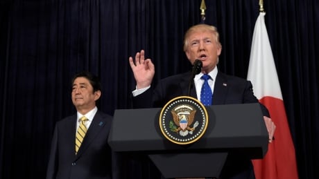 President Donald Trump speaks as Japanese Prime Minister Shinzo Abe listens as they both made statements about North Korea at Mar-a-Lago in Palm Beach, Fla., Saturday, Feb. 11, 2017. APTOPIX Trump US Japan