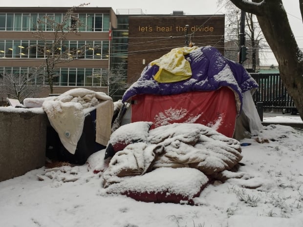 Let's heal the divide - homeless camper in snow Vancouver