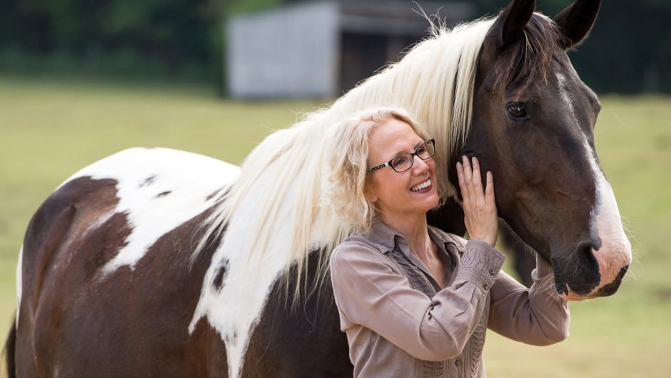 Laurie Wheeler poses with her horse Jazz. Wheeler is fighting the state of Tennessee, which has barred her from practising massage therapy on horses without a veterinary licence.
