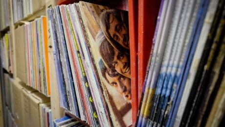 Members of the band "The Monkeys" peer out from a vinyl record cover at Canada Boy Vinyl, the only vinyl record factory in Canada, at the facility in Calgary, Alta., Thursday, Oct. 22, 2015.THE CANADIAN PRESS/Jeff McIntosh MUSIC Canada Boy Vinyl 20151105