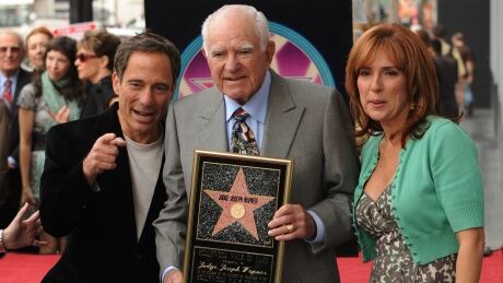 Judge Joseph A. Wapner, centre, poses on Nov. 12, 2009 with a copy of his star from the Hollywood Walk of Fame with Harvey Levin, left, who once worked on the show, and Marilyn Milian, who also had a TV courtroom show. Wapner