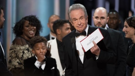 A handout photo made available by the Academy of Motion Picture Arts and Science (AMPAS) on 26 February 2017 shows Warren Beatty trying to explain the envelope mishap that ended the 89th annual Academy Awards ceremony in stunning fashion. USA ACADEMY AWARDS 2017