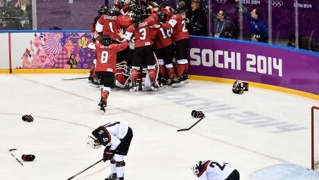 Canada, seen here celebrating its gold medal overtime victory against the United States at the 2014 Sochi Olympics, returns 13 of the women's players from that squad for next month's world hockey championship in Plymouth, Mich. canada-worlds-140220-1180
