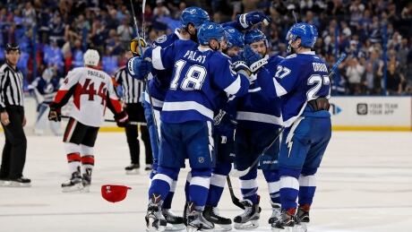 Members of the Tampa Bay Lightning congratulate Nikita Kucherov, centre, on his third goal of the second period against the Ottawa Senators. senators-lightning