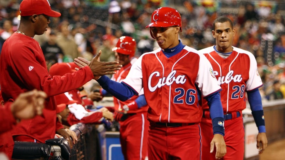 Leonys Martin #26 and teammate Hector Olivera #28 are congratulated by teammates during the 2009 World Baseball Classic in San Diego, California. Martin and Olivera have since defected to the U.S.