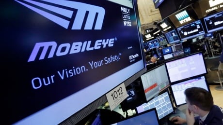 The Mobileye logo appears on a screen at the post where it trades on the floor of the New York Stock Exchange, Monday, March 13, 2017. Intel will buy Israel's Mobileye in a deal valued at just over $14 billion, the latest push by a major tech company to advance autonomous vehicles that could change the way traffic moves globally. Financial Markets Wall Street Intel Mobileye