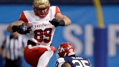 East tight end Antony Auclair, (89), of Laval, attempts to hurdle West cornerback Tyquwan Glass (25), of Fresno State, during the second half of the East West Shrine football game Saturday, Jan. 21, 2017, in St. Petersburg, Fla. For the majority of football players, a pro day is an opportunity to show off their athleticism. On Monday, Auclair used his to display his grit and toughness.The Laval Rouge et Or tight end went through his paces before 17 NFL scouts. And the native of Notre-Dame-des-Pins, Que., did so despite suffering a pulled hamstring roughly 10 days ago. THE CANADIAN PRESS/ AP/Chris O'Meara FBN Pro Day Auclair 20170313