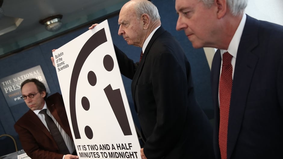 Members of the Bulletin of Atomic Scientists unveil the 2017 time for the "Doomsday Clock" January 26, 2017 in Washington, DC. For the first time in the 70-year history of the Doomsday Clock, the Bulletin of Atomic Scientists moved the clock forward 30 seconds to two and a half minutes before midnight, citing "ill-considered" statements by U.S. President Donald Trump on nuclear weapons and climate change, developments in Russia, North Korea, India and Pakistan. From left to right are theoretical physicist Lawrence Krauss, former U.S. Ambassador to the United Nations Thomas Pickering and retired U.S. Navy Rear Admiral David Titley.